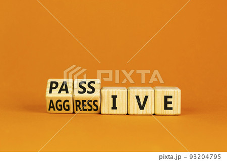 Passive or aggressive symbol. Wooden cubes, changed the concept word passive to aggressive. Beautiful orange table, orange background, copy space. Business, psychological passive aggressive concept. Passive or aggressive symbol. Wooden cubes, changed the concept word passive to aggressive. Beautiful orange table, orange background, copy space. Business, psychological passive aggressive concept. 93204795