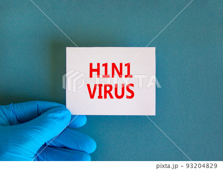H1N1 virus symbol. White note with words H1N1 virus, beautiful blue background, doctor hand in blue glove. Medical, H1N1 virus concept. 93204829