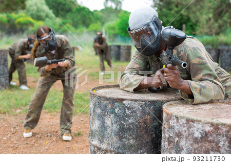 Afro american man paintball player in camouflage with gun Afro american man paintball player in camouflage with gun 93211730