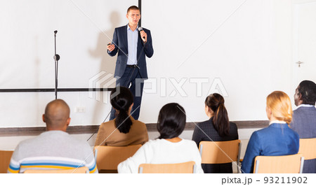 Confident lecturer speaking to businesspeople at seminar Confident lecturer speaking to businesspeople at seminar 93211902