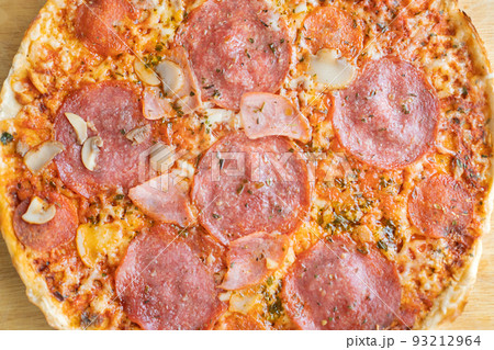 Hot meat pizza with salami, bacon and cheese. Selective focus. 93212964