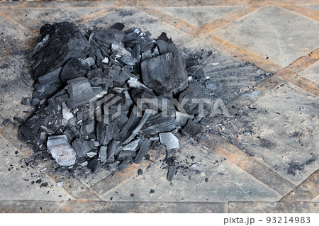 Pile of charcoal lies on floor in anticipation of heating season in northern latitudes of planet. Pile of charcoal lies on floor in anticipation of heating season in northern latitudes of planet. 93214983