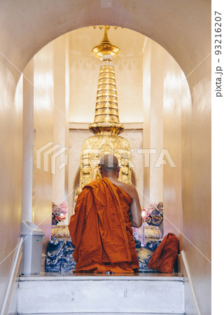 Buddhist monk sitting for meditation and respect for the Buddha relics inside the Golden mountain pagoda of Wat Saket, Thailand. Buddhist monk sitting for meditation and respect for the Buddha relics inside the Golden mountain pagoda of Wat Saket, Thailand. 93216207
