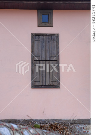 Old closed wooden shutters. Facade of the house. Old closed wooden shutters. Facade of the house. 93221741