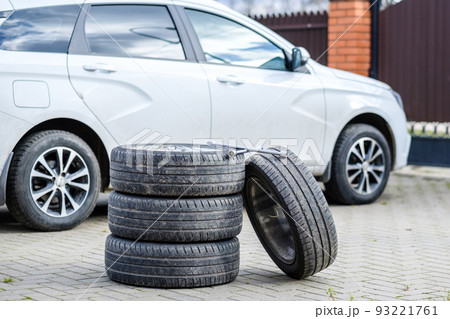 The wrench rests on the foot of the car wheels.  93221761