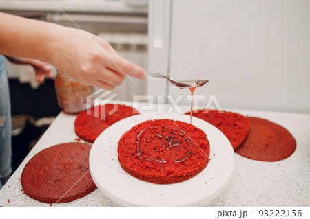 Pastry chef makes delicious red velvet cake. Cooking cake base. 93222156