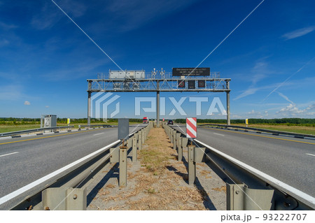 View of the highway on a summer day. Road signs over the road.  93222707