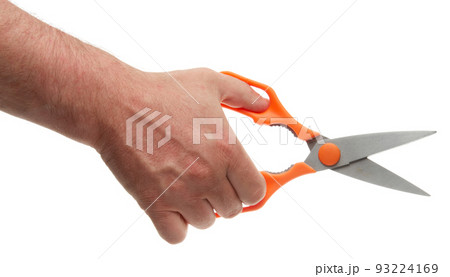 Hand with metal scissors with orange plastic handles. Isolated on white background with clipping path 93224169