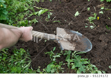 Human hands with shovel digging garden bed or farm. Farming, gardening, agriculture and people concept 93224172