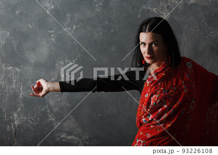 Young adult spanish woman dancing flamenco on gray vintage studio background Young adult spanish woman dancing flamenco on gray vintage studio background 93226108