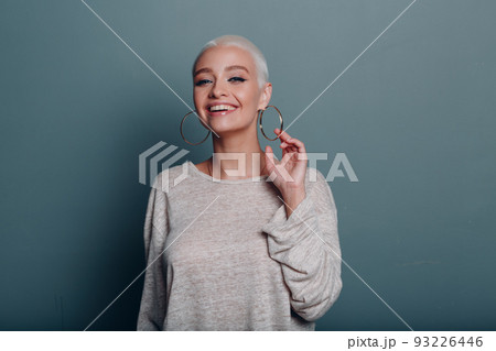 Millenial young woman with short blonde hair smiling portrait Millenial young woman with short blonde hair smiling portrait 93226446
