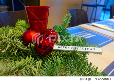 Green spruce branch and candlestick with the inscription Merry Christmas and Happy New Year. 93228064