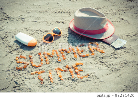 Inscription summer time, accessories for sunbathing and passport with currencies euro on sand 93231420