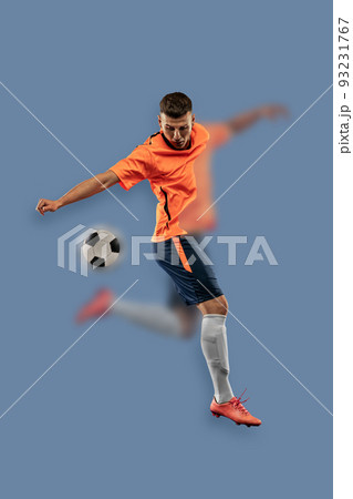Portrait with blurring effect. Young male soccer or football player kicking ball for the goal in jump. Concept of sport, World Cup tournament 93231767