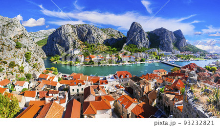 Landmarks of Croatia - impressive Omis town surrounded with mountain gorge, over Cetina river. Popular tousrit destination 93232821