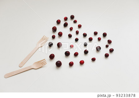 wooden bamboo cutlery and berries on white background, zero waste, no plastic, eco-friendly concept 93233878