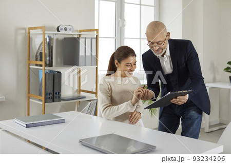 Happy client signs a contract agreement at the loan broker or insurance agent's office 93234206