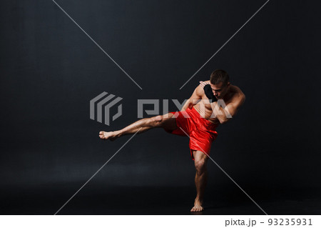Sportsman muay thai man boxer stance at black background. 93235931