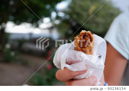 Unhealthy food. The teenager eats sweets. Hand with sweets close-up. Unhealthy food. The teenager eats sweets. Hand with sweets close-up. 93236154