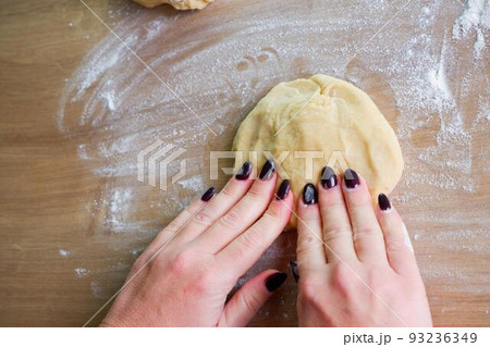 Homemade bread baking. Closeup woman hands kneading The Dough. Beautiful, cook. Dough for pizza or bread. 93236349