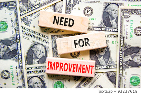 Need for improvement and support symbol. Concept words Need for improvement on wooden blocks. Beautiful background from dollar bills. Business, need for improvement quote concept. Copy space. 93237618
