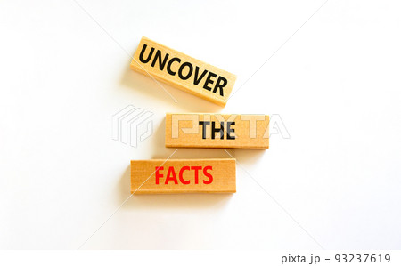 Uncover the facts symbol. Concept words Uncover the facts on wooden blocks on a beautiful white table white background. Business and uncover the facts concept. Copy space. 93237619