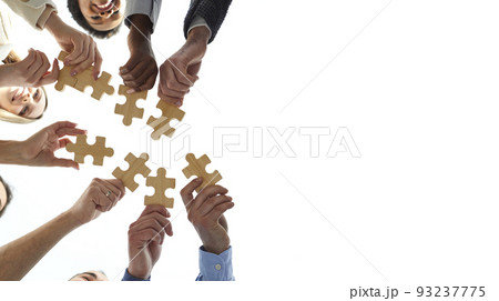 Copy space background with diverse team of business people joining jigsaw puzzle pieces 93237775