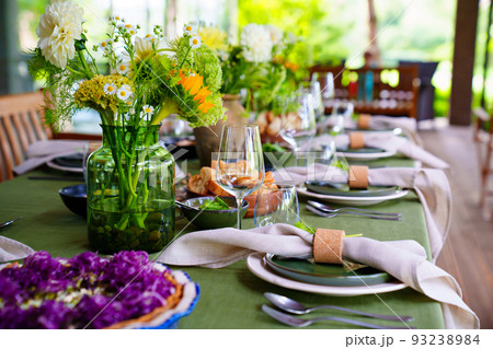 beautiful setting of a large table with flowers. beautiful setting of a large table with flowers. 93238984