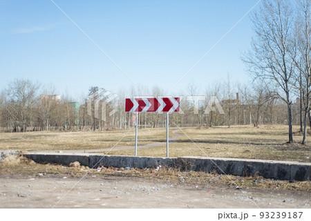road signs on the background of trees without leaves in the field 93239187