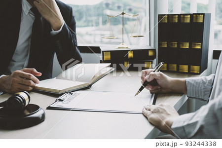 Businessman hand sign contract after lawyer providing legal consult dispute 93244338