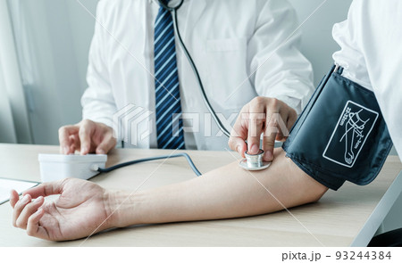 Doctor evaluates the patient with a stethoscope, blood pressure monitor and records the results, health medical checkup concept 93244384