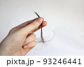 長い抜け毛を持つ女性の手 93246441