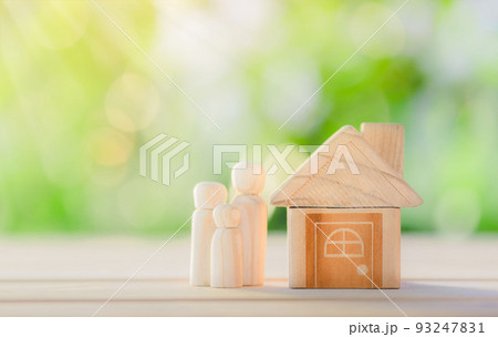 Wooden home with happy family of wooden doll is placed inside on nature bokeh. The saving money for house or real estate owner in the future concept. Wooden home with happy family of wooden doll is placed inside on nature bokeh. The saving money for house or real estate owner in the future concept. 93247831