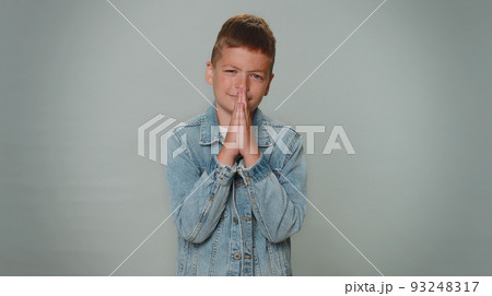 Toddler boy child kid praying, looking upward and making wish, asking for help , begging apology 93248317