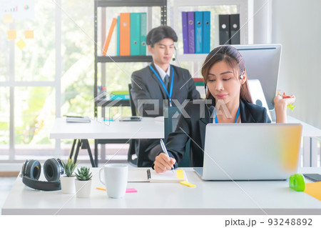 Asian. Female Operator is answering the phone for customer service sale and business consultant in a support office. Asian. Female Operator is answering the phone for customer service sale and business consultant in a support office. 93248892