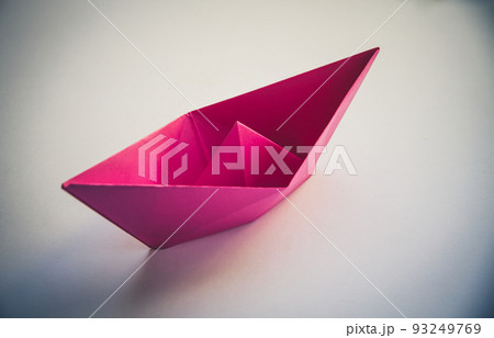 Pink paper boat origami isolated on a white background 93249769