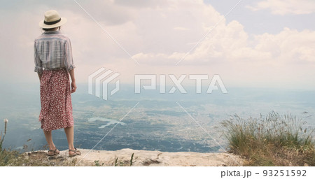 Traveler enjoying city view on mountain top. Happy woman traveler stands on mountain top, looks at scenery view of Tirana city, Albania. Dream travel concept, inspiration. Free wind blows girl's dress Traveler enjoying city view on mountain top. Happy woman traveler stands on mountain top, looks at scenery view of Tirana city, Albania. Dream travel concept, inspiration. Free wind blows girl's dress 93251592