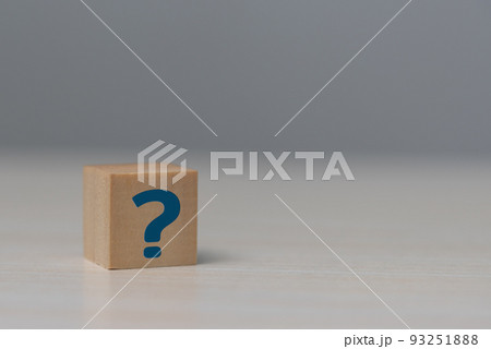 Wooden cube block shape with sign question mark symbol on table. Wooden cube block shape with sign question mark symbol on table. 93251888