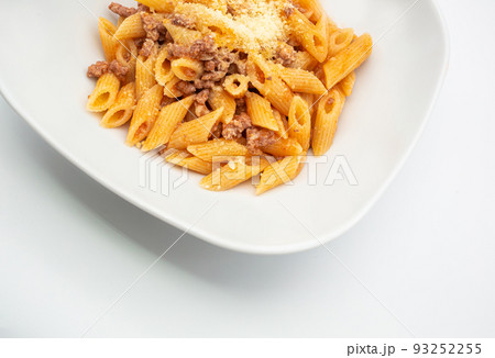 Homemade dish of delicious italian penne pasta with slowcooked bolognese ragu sauce and cheese. Top view. Concept Italian Cuisine Homemade dish of delicious italian penne pasta with slowcooked bolognese ragu sauce and cheese. Top view. Concept Italian Cuisine 93252255