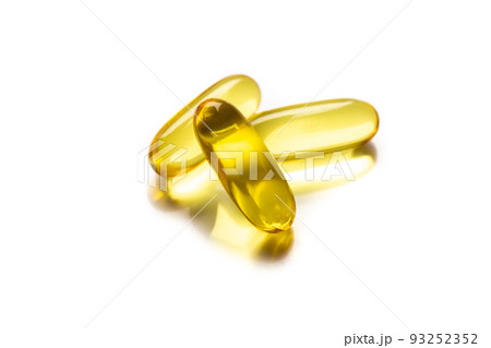 Close up of food supplement oil filled softgel/capsules suitable for fish oil, omega 3-6-7-9 on white background. Concept Healthy lifestyle Close up of food supplement oil filled softgel/capsules suitable for fish oil, omega 3-6-7-9 on white background. Concept Healthy lifestyle 93252352