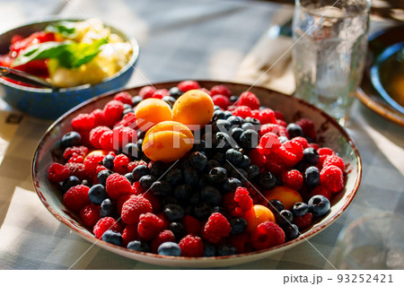 a plate of berries. raspberries, blueberries and apricots in a large dish. a plate of berries. raspberries, blueberries and apricots in a large dish. 93252421