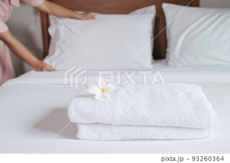 towels and Plumeria on the bed in the luxury hotel room ready for tourist travel towels and Plumeria on the bed in the luxury hotel room ready for tourist travel 93260364