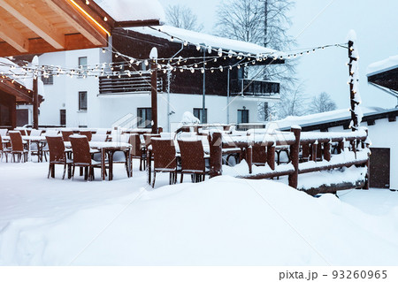 Empty outdoor cafe in a snowy ski resort. Outdoor cafe in winter under snow. Empty outdoor cafe in a snowy ski resort. Outdoor cafe in winter under snow. 93260965