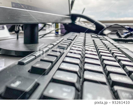 black keyboard in the office. computer work. plastic keyboard with large letters and numbers. next to it is a black telephone with a plastic handset black keyboard in the office. computer work. plastic keyboard with large letters and numbers. next to it is a black telephone with a plastic handset 93261410