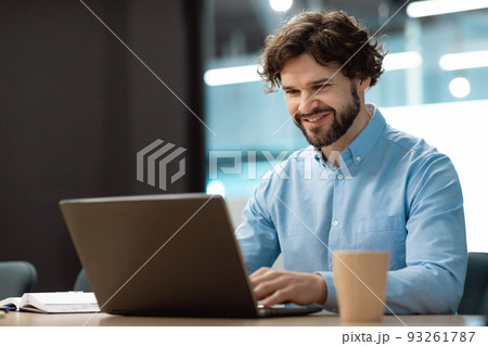 Handsome mature businessman working with laptop pc at his desk in office, blank space Handsome mature businessman working with laptop pc at his desk in office, blank space 93261787