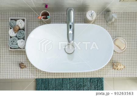 sink wash basin and personal hygiene items such as toothbrushes, soap, towel in the bathroom. sink wash basin and personal hygiene items such as toothbrushes, soap, towel in the bathroom. 93263563