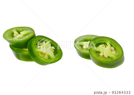 Fresh green cut chili pepper pieces isolated on white background. 93264333