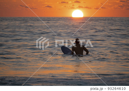 Silhouette of Surfer waiting on the line up for a wave at sunrise or sunset 93264610