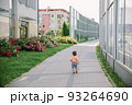 Adorable little 1-2 year old toddler boy walking along the street in Cracow, Poland 93264690