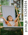 Adorable little 1-2 year old toddler boy having fun on sunbed in Krakow, Poland 93264694